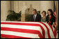 President George W. Bush and Laura Bush pay their respects to Chief Justice William Rehnquist as his body lies in repose in the Great Hall of the U.S. Supreme Court Tuesday, Sept. 6, 2005. Standing as honor guard for the Chief Justice is one of his former law clerks, Courtney Ellwood. White House photo by Eric Draper