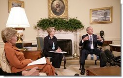 President George W. Bush, seen with U.S. Secretary of Education Margaret Spellings, center, and Laura Bush, left, gestures as he speaks with reporters, Tuesday, Sept. 6, 2005 in the Oval Office at the White House, about efforts the Department of Education is undertaking with a program, "Hurricane Help for Schools," established to assist schools and students affected by Hurricane Katrina.  White House photo by Eric Draper