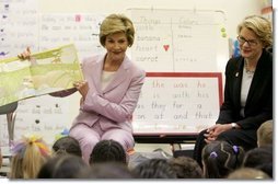 Laura Bush is joined by U.S. Education Secretary Margaret Spellings, right, as she reads a book to first graders at Lovejoy Elementary School in Des Moines, Iowa, Thursday, September 8, 2005.  White House photo by Krisanne Johnson