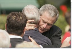 President George W. Bush embraces one of the hundreds of family and friends who gathered on the South Lawn of the White House, Friday, Sept. 9, 2005, during the 9/11 Heroes Medal of Valor Award Ceremony, in honor of the courage and commitment of emergency services personnel who died on Sept. 11, 2001.  White House photo by Paul Morse