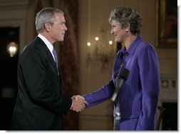 President George W. Bush congratulates Karen Hughes after her swearing-in by U.S. Secretary of State Condoleezza Rice, Friday, Sept. 9, 2005 at the State Department in Washington, to be the Under Secretary of State for Public Diplomacy.  White House photo by Eric Draper