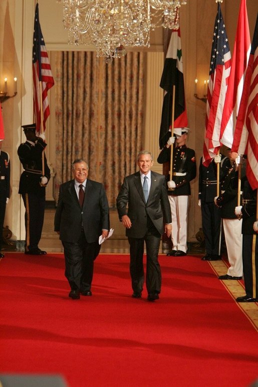 President George W. Bush and President Jalal Talabani of Iraq walk to the East Room of the White House Tuesday, Sept. 13, 2005, for a joint press availability. The President called Iraq "America's ally in the war against terrorism," and added, "freedom will win in Iraq." White House photo by Shealah Craighead
