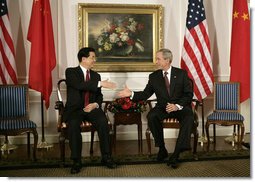 President George W. Bush and President Hu Jintao of China greet each other at the start of their meeting, Tuesday, Sept. 13, 2005, in New York. White House photo by Eric Draper