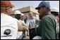 President George W. Bush greets construction workers outside the Folgers Coffee plant in in New Orleans, La., Tuesday, Sept. 20, 2005. White House photo by Eric Draper