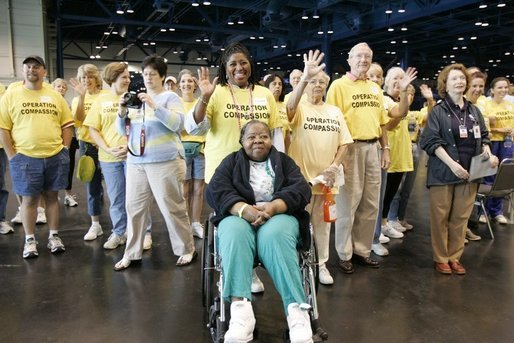 "Operation Compassion" volunteers wave to First Lady Laura Bush Monday, Sept. 19, 2005, as she visited Houston's George R. Brown Convention Center. The Convention Center was designated a shelter for Hurricane Katrina evacuees and since opening its doors Sept. 2, more than 35,000 have been served and approximately 46,000 volunteers have been trained. White House photo by Krisanne Johnson