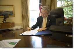 President George W. Bush signs into law H.R. 3169, the "Pell Grant Hurricane and Disaster Relief Act," which authorizes the Department of Education to waive requirements for Pell Grant repayments if student withdrawals from institutions of higher education are due to major disasters, Wednesday, Sept. 21, 2005, in the Oval Office. The President also signed into law two other hurricane-related bills: H.R. 3668, the "Student Grant Hurricane and Disaster Relief Act," and H.R. 3672, the "TANF Emergency Response and Recovery Act of 2005."  White House photo by Eric Draper