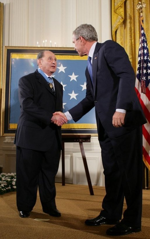 President George W. Bush congratulates Korean War era veteran Corporal Tibor " Ted" Rubin, after awarding Rubin the Medal of Honor, Friday, Sept. 23, 2005 at cermonies at the White House in Washington. Rubin was honored for his actions under fire, and his bravery while in captivity at a Chinese POW camp. White House photo by Paul Morse