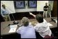 President George W. Bush and Texas Governor Rick Perry, right, participate in a meeting with Texas officials inside the Texas Emergency Operations Center in Austin, Texas, Saturday, Sept. 24, 2005. White House photo by Eric Draper
