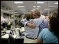 President George W. Bush hugs a worker while visiting with emergency personnel inside the Texas Emergency Operations Center in Austin, Texas, Saturday, Sept. 24, 2005. White House photo by Eric Draper