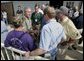 President George W. Bush speaks with Texas officials following a meeting about hurricane Rita at South Texas Regional Airport in Beaumont, Texas, Tuesday, Sept. 27, 2005. White House photo by Eric Draper