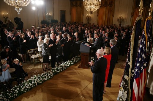 Chief Justice John G. Roberts receives a standing-ovation after he is sworn-in as the 17th Chief Justice of the United States, Thursday, Sept. 29, 2005 in the East Room of the White House in Washington. Chief Justice Roberts is applauded by President George W. Bush and fellow judges of the U.S. Supreme Court. White House photo by Paul Morse