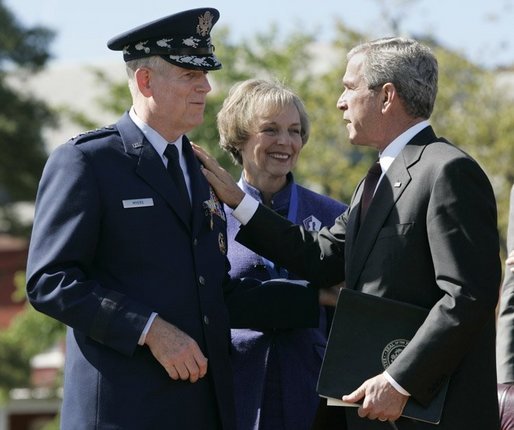 During the Armed Forces Farewell Tribute in Honor of General Richard B. Myers and Armed Forces Hail in Honor of General Peter Pace at Fort Myer's Summerall Field in Ft. Myer, Va., Friday, Sept. 30, 2005, President George W. Bush thanks General Richard B. Myers, with wife Mary Jo Myers, for his service as Chairman of the Joint Chiefs of Staff. White House photo by Paul Morse