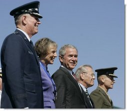 General Richard B. Myers, Mary Jo Myers, President George W. Bush, Secretary of Defense Donald Rumsfeld, and General Peter Pace, observe the March in Review, the Joint Service Medley and the Flyover during the Chairman of the Joint Chiefs of Staff change of command, Friday, Sept. 30, 2005, at The Armed Forces Farewell Tribute in Honor of General Richard B. Myers and Armed Forces Hail in Honor of General Peter Pace at Fort Myer's Summerall Field in Ft. Myer, Va. White House photo by Shealah Craighead