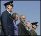 General Richard B. Myers, Mary Jo Myers, President George W. Bush, Secretary of Defense Donald Rumsfeld, and General Peter Pace, observe the March in Review, the Joint Service Medley and the Flyover during the Chairman of the Joint Chiefs of Staff change of command, Friday, Sept. 30, 2005, at The Armed Forces Farewell Tribute in Honor of General Richard B. Myers and Armed Forces Hail in Honor of General Peter Pace at Fort Myer's Summerall Field in Ft. Myer, Va. White House photo by Shealah Craighead