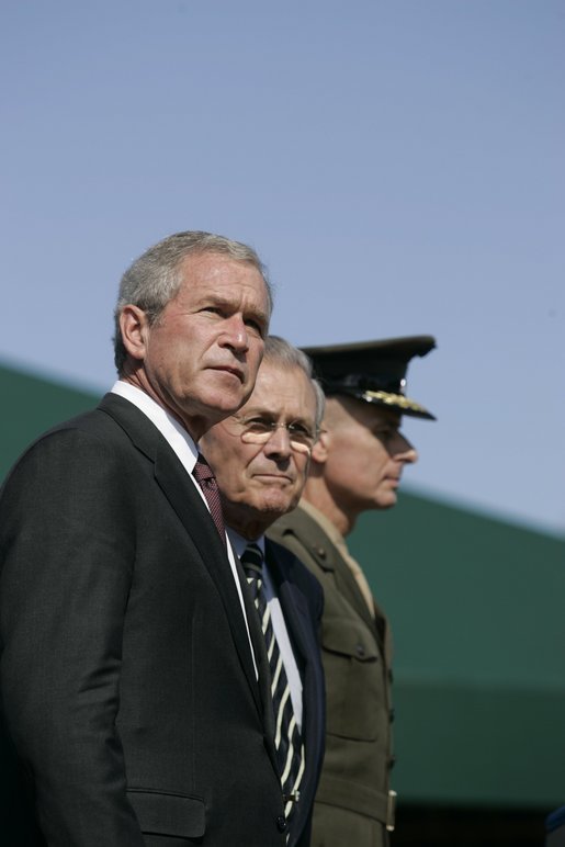 President George W. Bush stands with Defense Secretary Donald Rumsfeld and newly sworn-in Chairman of the Joint Chiefs of Staff, U.S. Marine General Peter Pace, Friday, Sept. 30, 2005 at the Armed Forces Farewell Tribute in Honor of General Richard B. Myers and Armed Forces Hail in Honor of General Pace at Fort Myer in Ft. Myers, Va. White House photo by Shealah Craighead