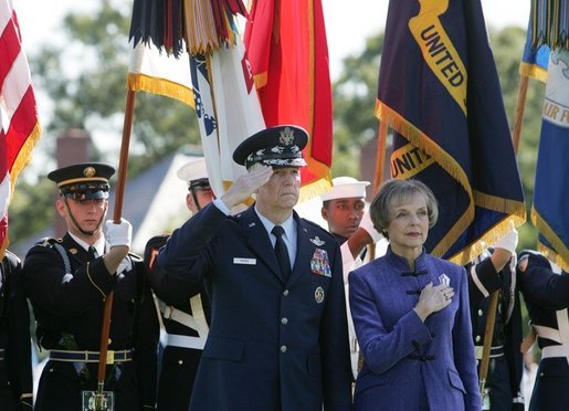 General Richard B Myers salutes as he stands with his wife, Mary Jo Myers, Friday, Sept. 30, 2005, during ceremonies at theThe Armed Forces Farewell Tribute in Honor of General Richard B. Myers and the Armed Forces Hail in Honor of General Peter Pace at Fort Myer, at Summerall Field in Ft. Myer, Va. White House photo by David Bohrer