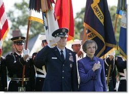 General Richard B. Myers salutes as he stands with his wife, Mary Jo Myers, Friday, Sept. 30, 2005, during ceremonies at theThe Armed Forces Farewell Tribute in Honor of General Richard B. Myers and the Armed Forces Hail in Honor of General Peter Pace at Fort Myer's Summerall Field in Ft. Myer, Va. White House photo by David Bohrer