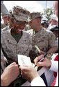 Vice President Dick Cheney shakes hands and signs autographs with U.S. Marine Personnel during a rally at Camp Lejeune in Jacksonville, NC, Monday, October 3, 2005. White House photo by David Bohrer