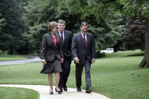 Harriet Miers escorts Supreme Court Associate Justice nominee John G. Roberts Jr. along the South Lawn sidewalk en route to the Oval Office to meet with President George W. Bush July 19, 2005. White House photo by Eric Draper