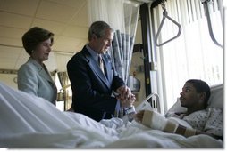 President George W. Bush and Mrs. Laura Bush talk with Sgt. Patrick Hagood of Anderson, S.C., Wednesday, Oct. 5, 2005, during their visit to Walter Reed Army Medical Center in Washington D.C. White House photo by Paul Morse