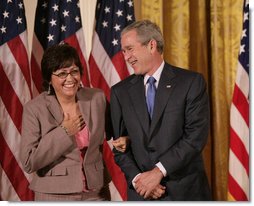 President George W. Bush stands with Volunteer Service Award recipient Maria Hines of Albuquerque, N.M., in the East Room of the White House, Friday, Oct. 7, 2005, where President Bush honored six recipients of the President's Volunteer Service Awards, as part of the celebration of Hispanic Heritage Month. White House photo by Eric Draper