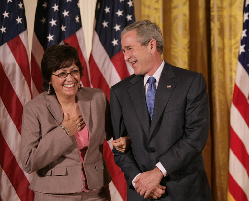 President George W. Bush stands with Volunteer Service Award recipient Maria Hines of Albuquerque, N.M., in the East Room of the White House, Friday, Oct. 7, 2005, where President Bush honored six recipients of the President's Volunteer Service Awards, as part of the celebration of Hispanic Heritage Month. White House photo by Eric Draper