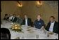 President George W. Bush, center, is seen Monday evening, Oct. 10, 2005 at the restaurant Bacco in New Orleans, La., sitting next to U. S. Coast Guard Vice Admiral Thad W. Allen, New Orleans Mayor Ray Nagin and joined by other local officials. White House photo by Eric Draper