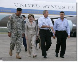 President George W. Bush and Laura Bush walk with Lt. General Russel Honore, left, and Plaquemines Parish president Benny Rousselle, right, upon their arrival Monday, Oct. 10, 2005 at the U.S. Naval Air Station, Joint Reserve Base in New Orleans, La.  White House photo by Eric Draper