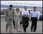 President George W. Bush and Laura Bush walk with Lt. General Russel Honore, left, and Plaquemines Parish president Benny Rousselle, right, upon their arrival Monday, Oct. 10, 2005 at the U.S. Naval Air Station, Joint Reserve Base in New Orleans, La. White House photo by Eric Draper