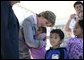 Laura Bush gives a hug to a student at Delisle Elementary School in Pass Christian, Miss., Tuesday, Oct. 11, 2005, as the school reopened for the first time since the area was struck by Hurricane Katrina. White House photo by Eric Draper