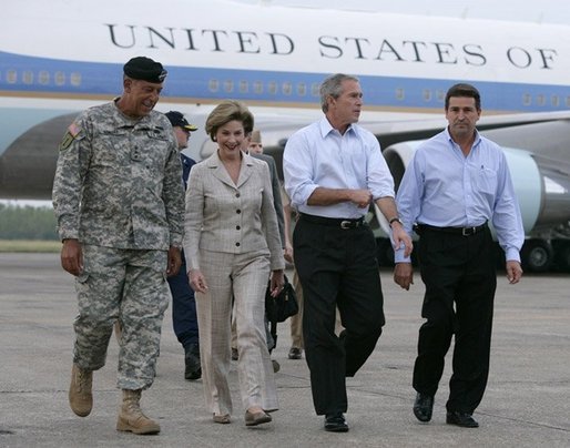 President George W. Bush and Laura Bush walk with Lt. General Russell Honore, left, and Plaquemines Parish president Benny Rousselle, right, upon their arrival Monday, Oct. 10, 2005 at the U.S. Naval Air Station, Joint Reserve Base in New Orleans, La. White House photo by Eric Draper