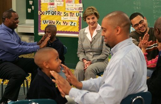 Laura Bush watches fathers play a game with their children in the R.E.A.D. to Kids Training Program at J.S. Chick Elementary School in Kansas City, Mo., Tuesday, October 11, 2005. White House photo by Krisanne Johnson