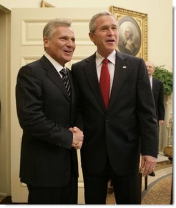 President George W. Bush welcomes Poland's President Aleksander Kwasniewski to the Oval Office at the White House, Wednesday, Oct. 12, 2005 in Washington.  White House photo by Eric Draper
