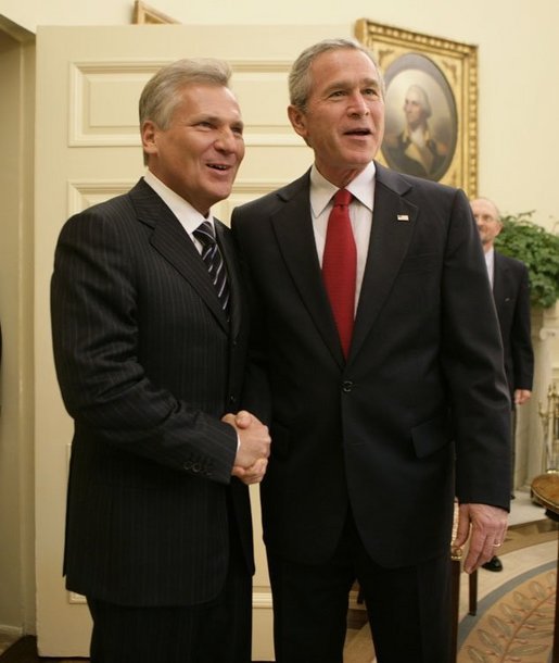 President George W. Bush welcomes Poland's President Aleksander Kwasniewski to the Oval Office at the White House, Wednesday, Oct. 12, 2005 in Washington. White House photo by Eric Draper