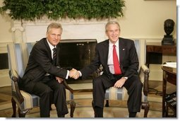 President George W. Bush and Poland's President Aleksander Kwasniewski shake hands as they meet with reporters in the Oval Office at the White House, Wednesday, Oct. 12, 2005 in Washington.  White House photo by Eric Draper