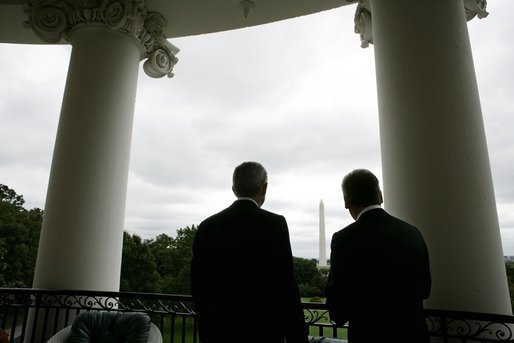 President George W. Bush and Poland's President Aleksander Kwasniewski look toward the Washington Monument, as they stand together on the Truman Balcony at the White House, Wednesday, Oct. 12, 2005 in Washington. White House photo by Eric Draper