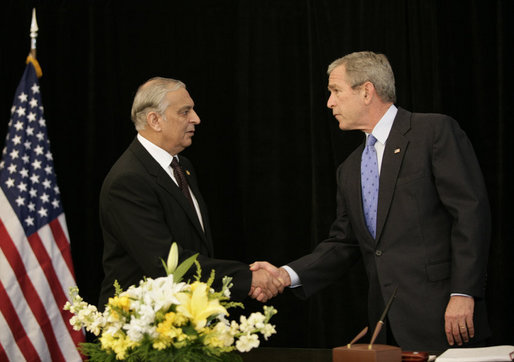 President George W. Bush shakes hands with Pakistan's Ambassador Jehangir Karamat, after signing a book of condolences, Friday, Oct. 14, 2005 at the Pakistan Embassy in Washington, to express the condolences of the American people for those who suffered as a result of the recent earthquake that struck Pakistan. White House photo by Eric Draper