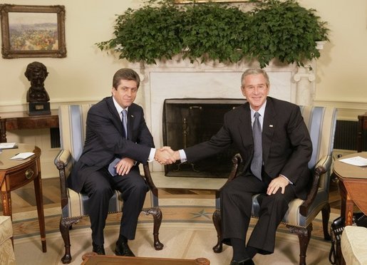 President George W. Bush shakes hands with Bulgarian President Georgi Purvanov prior to taking questions from reporters, Monday, Oct. 17, 2005, in the Oval Office at the White House in Washington. White House photo by Eric Draper