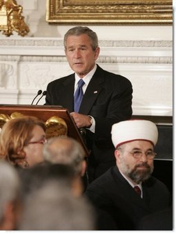 President George W. Bush welcomes guests to the Iftaar Dinner with Ambassadors and Muslim Leaders, held in the State Dining Room of the White House, Monday, Oct. 17, 2005 in Washington.  White House photo by Paul Morse