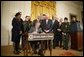 President George W. Bush is joined by legislators, cabinet members and law enforcement officials, Tuesday, Oct. 18, 2005 in the East Room of the White House, as he signs the Homeland Security Appropriations Act for fiscal year 2006. White House photo by Paul Morse