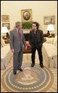 President George W. Bush and Bono discuss global AIDS and Africa policy in the Oval Office Wednesday, Oct. 19, 2005, following lunch in the White House. White House photo by Eric Draper