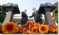 President George W. Bush and President Mahmoud Abbas, of the Palestinian Authority, shake hands after speaking with the media Thursday, Oct. 20, 2005, in the Rose Garden of the White House.  White House photo by Paul Morse