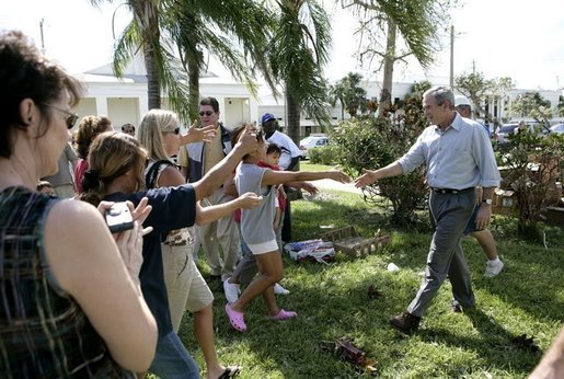President George W. Bush greets local residents lined up at a food and water distribution center, Thursday, Oct. 27, 2005, in the hurricane damaged area of Pompano Beach, Fla. White House photo by Eric Draper
