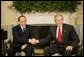 President George W. Bush shakes hands with Italian Prime Minister Silvio Berlusconi, during his visit to the Oval Office at the White House, Monday, Oct. 31, 2005 in Washington. White House photo by Eric Draper