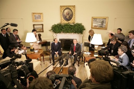 President George W. Bush talks to reporters during a visit with Italian Prime Minister Silvio Berlusconi in the Oval Office at the White House, Monday, Oct. 31, 2005 in Washington. White House photo by Eric Draper