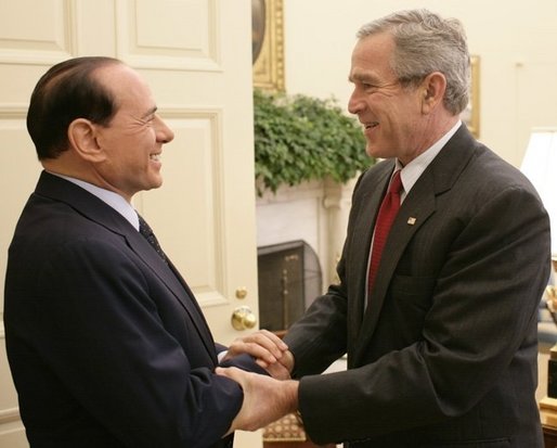 President George W. Bush welcomes Italian Prime Minister Silvio Berlusconi to the Oval Office at the White House, Monday, Oct. 31, 2005 in Washington. White House photo by Eric Draper
