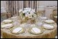 The table settings in the State Dining Room for the White House dinner Wednesday, Nov. 2, 2005, in honor of the Prince of Wales and Duchess of Cornwall. Chosen by Mrs. Laura Bush, the centerpieces are sprays of white phaeleanopsis orchids displayed in vermeil vases and compliment the Clinton China and vermeil flatware. White House photo by Shealah Craighead