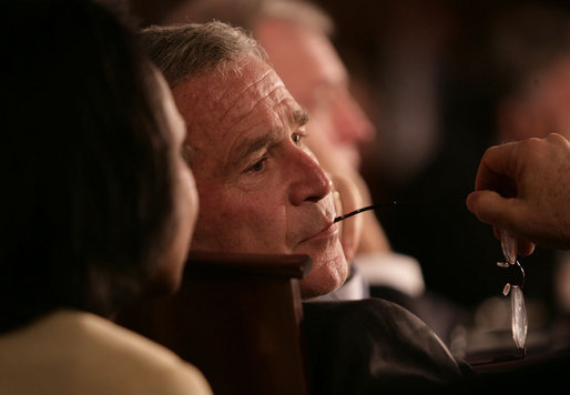 President George W. Bush listens to Secretary of State Condoleezza Rice during the opening session Friday, Nov. 4, 2005, of the 2005 Summit of the Americas in Mar del Plata, Argentina. White House photo by Eric Draper