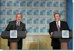 President George W. Bush and Argentina's President Nestor Carlos Kirchner smile as they hold a joint press availability Friday, Nov. 4, 2005, after meeting privately at the Hermitage Hotel in Mar del Plata, Argentina. White House photo by Paul Morse