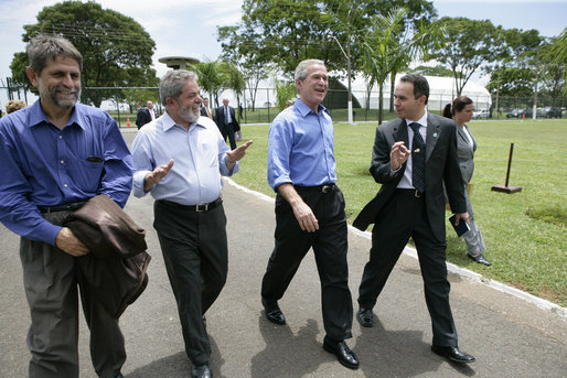 President George W. Bush enjoys a walk with Brazilian President Luiz Inacio Lula da Sliva following their joint statement at the Granja do Torto in Brasila, Brazil, Sunday, Nov. 6, 2005. White House photo by Eric Draper